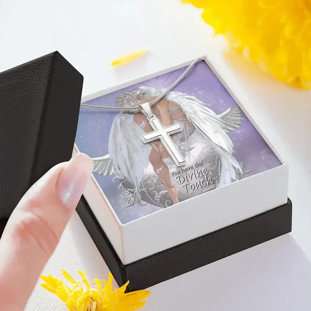 Silver cross necklace in gift box with angel illustration and 'You have the Divine Touch' message, surrounded by yellow flowers.
