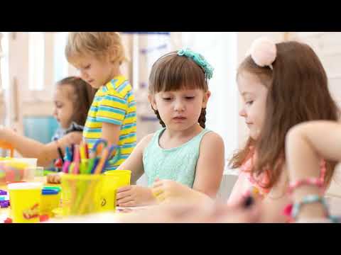 Children engaged in creative activities with colorful art supplies at a table.